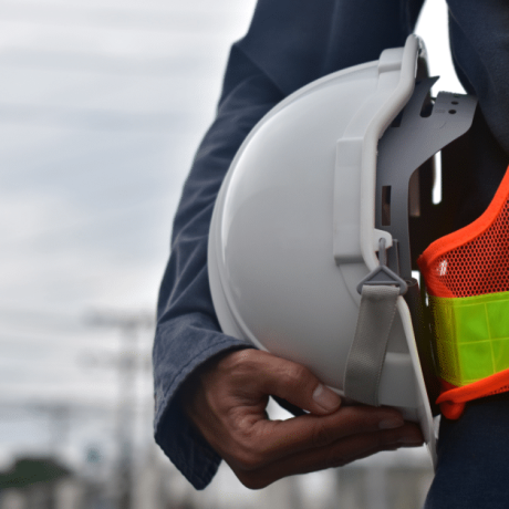 close up image of a construction worker holding a hardhat